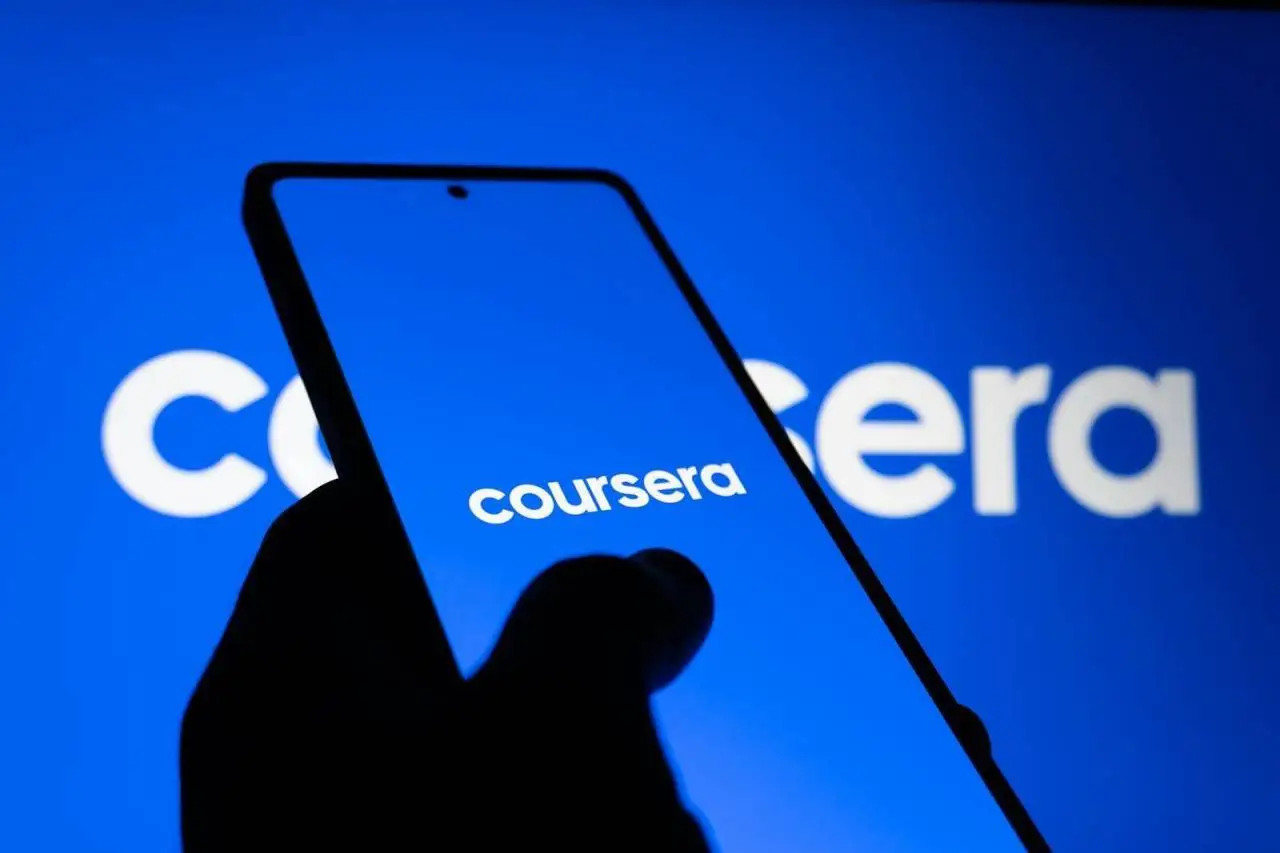 A smartphone displaying the Coursera logo against a bright blue background, symbolizing online learning.